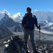 Govinda Prasad Sapkota standing at the summit of Chukhung Ri, overlooking Chukhung Valley in the Everest region