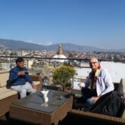 GovindaPrasad Sapkota with special Lithuanian guest enjoying coffee at hotel rooftop overlooking Boudhanath Stupa
